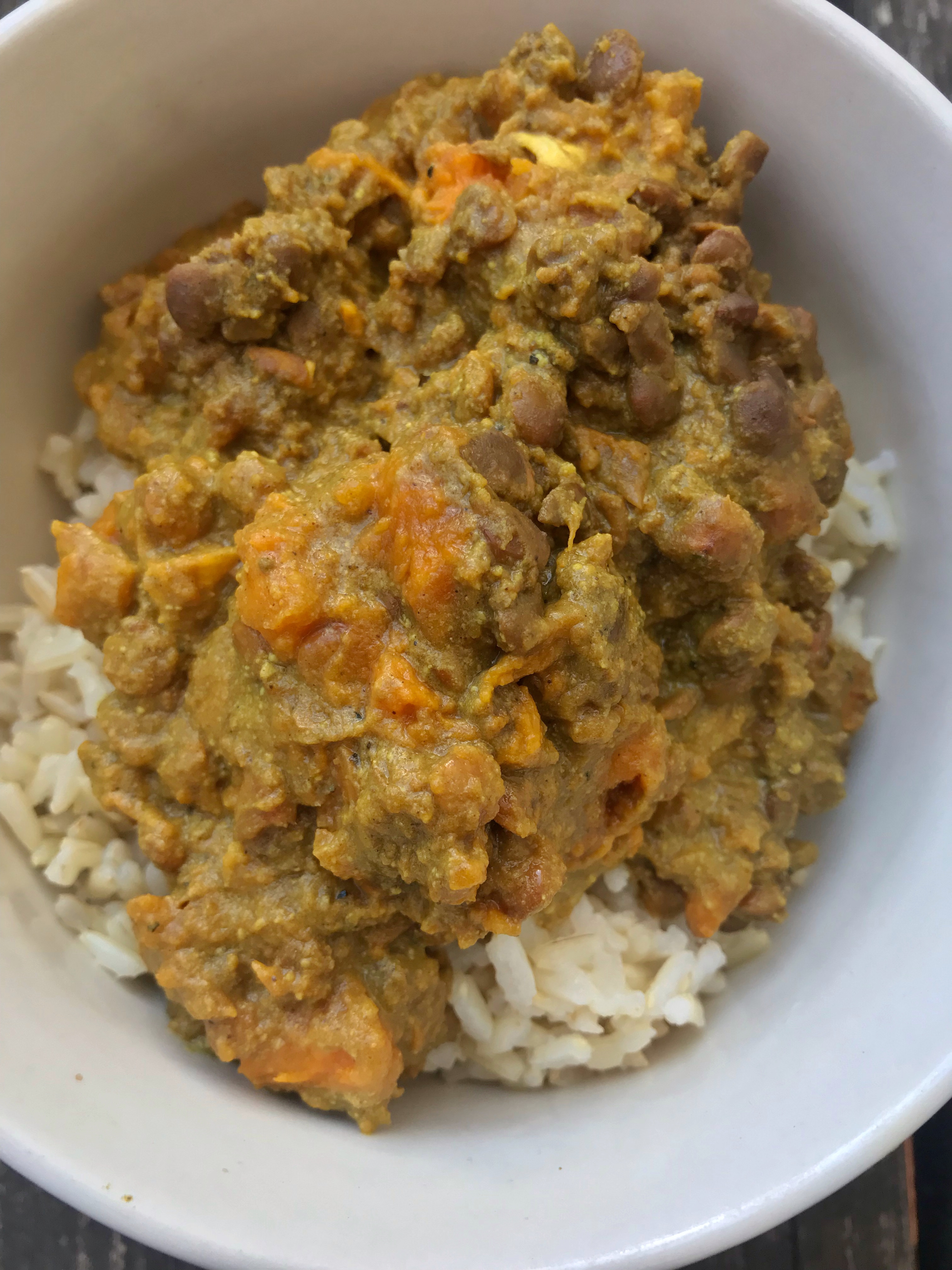 Sweet potato lentil curry over a bed of rice in a bowl
