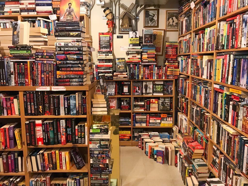 Rows of second-hand books line the shelves at a shop.