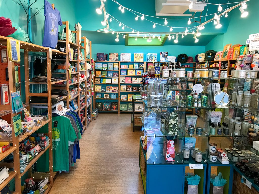 The interior of an indie shop featuring quirky goods and turquoise walls.