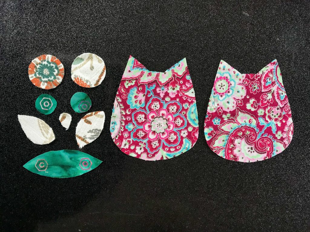 Cut out fabric pieces of an owl ornament
