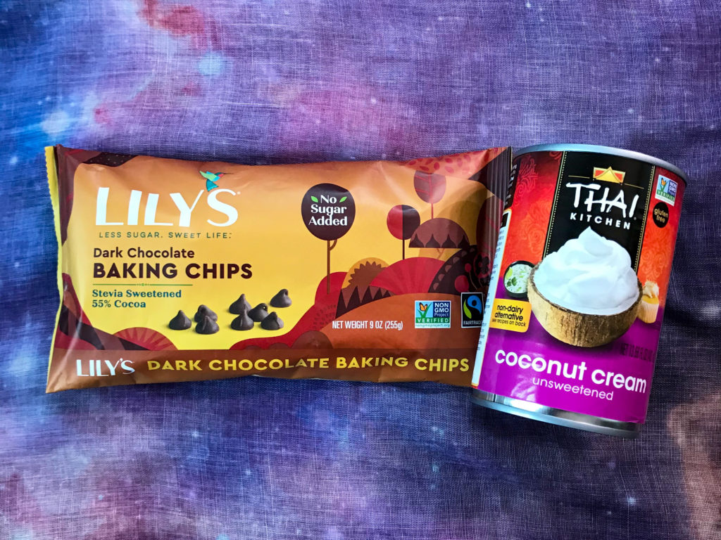 A bag of Lily's chocolate chips and a can of Thai Kitchen coconut cream on top of a purple space background.