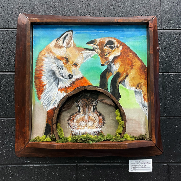 A painting depicting foxes dancing in space while a rabbit hides under a log.